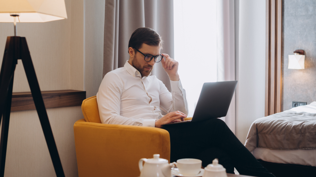 Hotel guest working on laptop